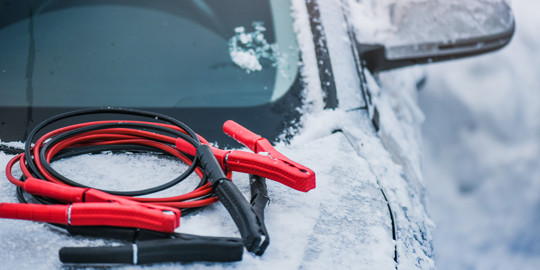 Choosing the Best Jump Starter - Jumper Cables on Car